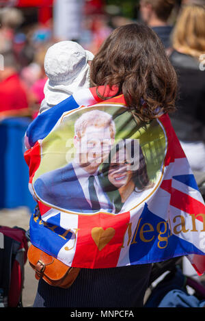 Woman wrapped in Union Jack flag at a public screening of the royal wedding of Prince Harry and Meghan Markle. Ringwood, Hampshire, England, UK, 19th May 2018. Stock Photo
