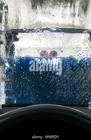 Car Wash With Blue Scrub Rollers In Tunnel Stock Photo