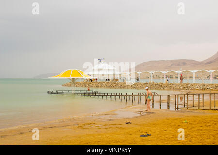 The Ein Bokek beach at the Lot Hotel on the Dead Sea in Judea Israel. Tourists enjoying the amenities  as they prepare for floating in the sea Stock Photo