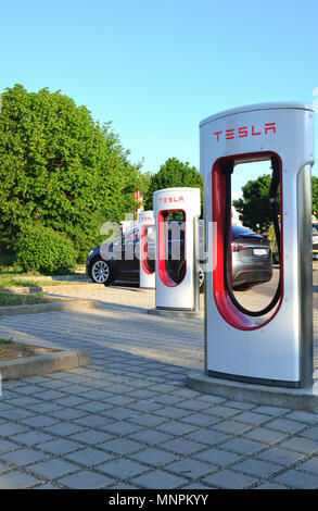 Ellwangen, Germany - May 10, 2018: Tesla Supercharger Stations (480-volt DC fast-charging stations) and Tesla car in background. Stock Photo