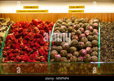 Racks of tea and spice varieties sold at Istanbul Spice Bazaar in muted color tone. There are dried flower tea like rose, jasmine, and tea made from r Stock Photo