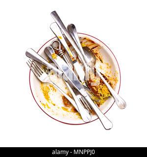 Curry Left overs in a bowl with knives, spoons and Forks on a white background Stock Photo