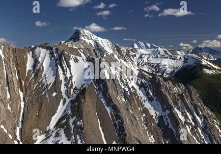 Springtime View of Rugged Snowcapped Mountains from Wasootch Peak Summit in Kananaskis Country near Banff National Park in Canadian Rockies Stock Photo
