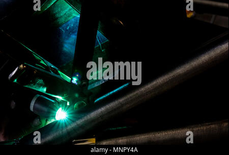 Man tig welding with brilliant bright white star burst blooms of lights Stock Photo