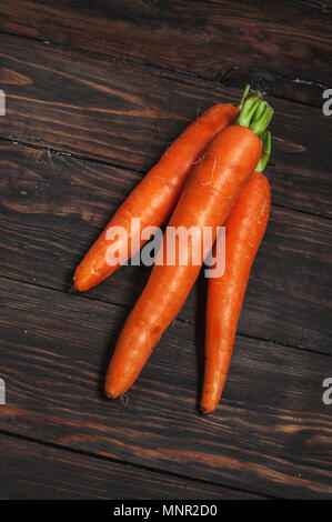 Fresh carrots bunch on rustic wooden background. Stock Photo