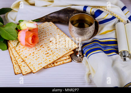 Pesah celebration concept jewish Passover holiday Matzoh and red sweet wine and spring flowers Stock Photo