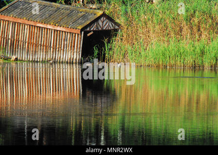A beautiful scene of a boat house reflected on a South African river. Stock Photo