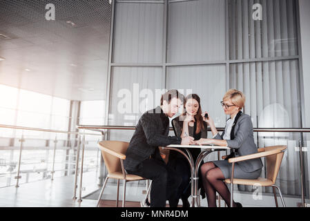 business, technology and office concept - smiling female boss talking to business team Stock Photo