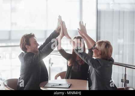 Start up business. Group of young architect at office. group of business partners giving high five Stock Photo