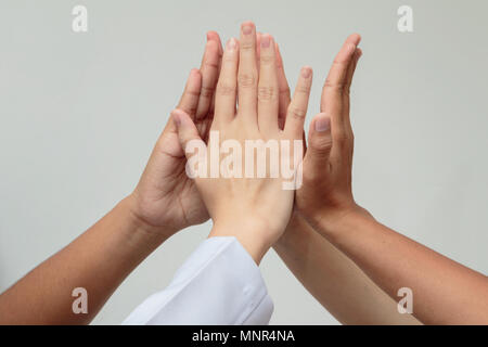 Doctors and nurses in a medical team stacking hands,Medical team cooperation Stock Photo