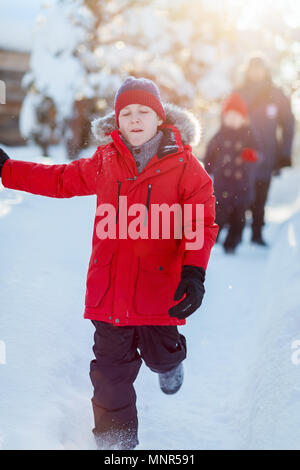 Cute boy in a red parka down jacket outdoors on beautiful winter snowy day Stock Photo Alamy