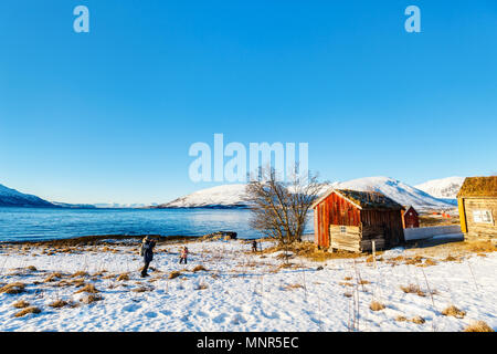 Beautiful winter landscape of Northern Norway with wooden huts overlooking breathtaking fjords scenery Stock Photo