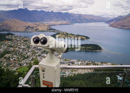 Fixed binoculars at the top of the Skyline Gondola showing the view over Queenstown and Lake Wakatipu in New Zealand