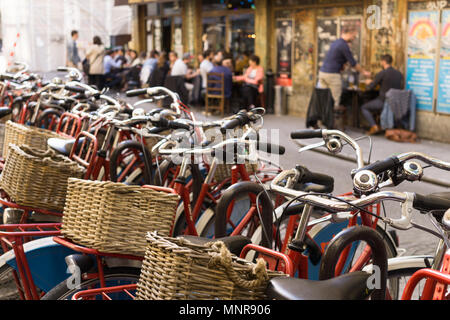 Rental city bicycles with woven baskets in Paris, France.