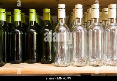 Background wall from empty bottles of wine on wooden shelve drinks Stock Photo