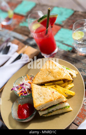 Delicious fresh fish sandwich and green salad served for lunch Stock Photo