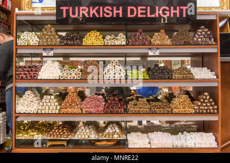 A glass case in front of shop holds an assortment of tempting Turkish delights for sale at Istanbul Spice bazaar in Turkey Stock Photo