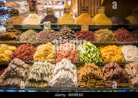Orderly piles of various dried fruits, spices and other goods  on display in market stall at Istanbul Spice bazaar in Turkey Stock Photo