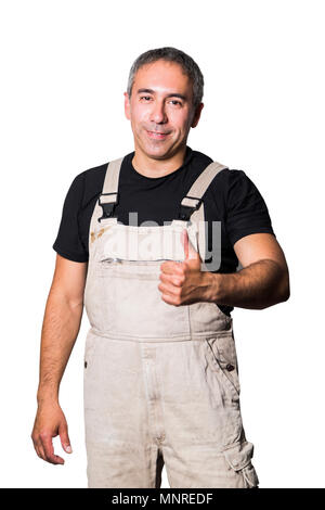 Confident male man worker specialist plumber, engineer or constructor in white dirty old shabby working suit, black t-shirt show thumbs up as success  Stock Photo