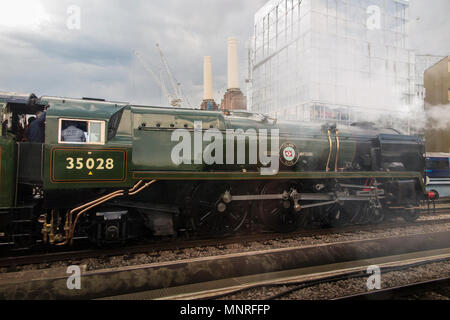 A steam engine locomotive  on it's way past the iconic Battersea Power Station in Central London Stock Photo