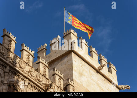 Exterior view of the La Lonja building with the flag of the Valencian Community waving in the wind. Valencia. Spain Stock Photo