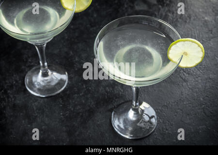Gimlet Cocktail. Alcoholic Lime and Gin Gimlet on black background, copy space. Stock Photo