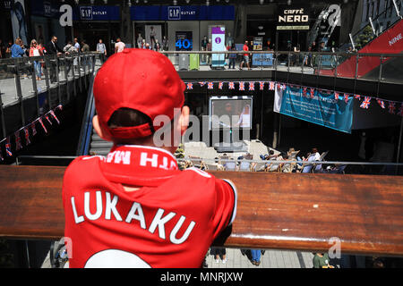 A young Manchester United fan watches the Royal Wedding from the London Designer Outlet in Wembley Park, close to Wembley Stadium, the venue for the Emirates FA Cup Final. Picture date: Saturday May 19, 2018. See PA story ROYAL Wedding. Photo credit should read: Adam Davy/PA Wire Stock Photo