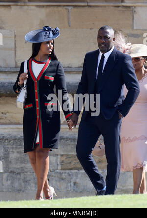 Sabrina Dhowre (left) and Idris Elba arrive at St George's Chapel at Windsor Castle for the wedding of Meghan Markle and Prince Harry. Stock Photo