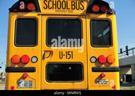 South Elgin, Illinois, USA.The rear of school bus stopped at an intersection fitted with its required emergency exit door. Stock Photo