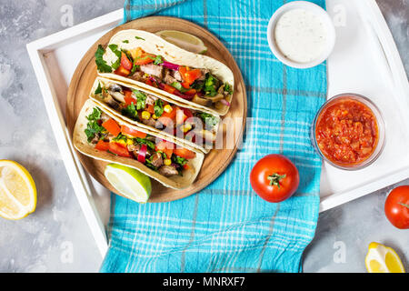 Mexican pork tacos with vegetables. Tacos al pastor on wooden blue rustic background. Top view Stock Photo