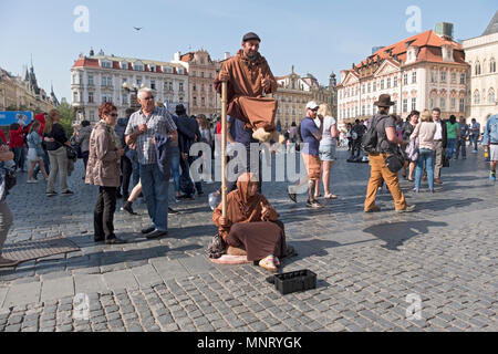 A buskers in the Old Town section of Prague  appearing to be doing a levitation act. Czech Republic. Stock Photo
