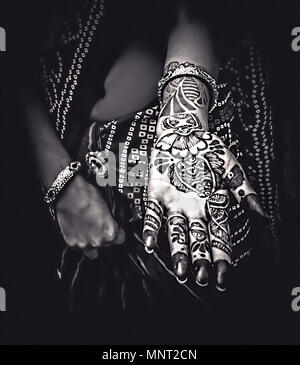 A Henna Tattoo on a young woman in Jaipur, India. Henna tattoos are an ancient form of body adornment and signify many blessing during ceremonies. Stock Photo