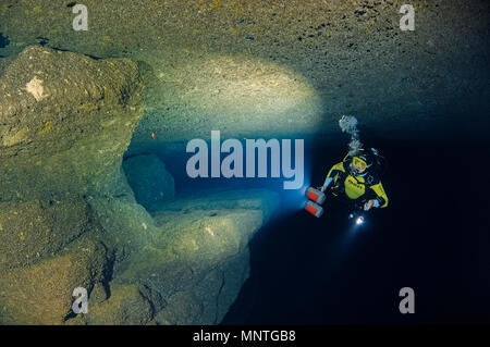woman scuba diver, exploring Billinghurst Cave, Gozo, Malta, Mediterranean Sea, Atlantic Ocean, MR Stock Photo