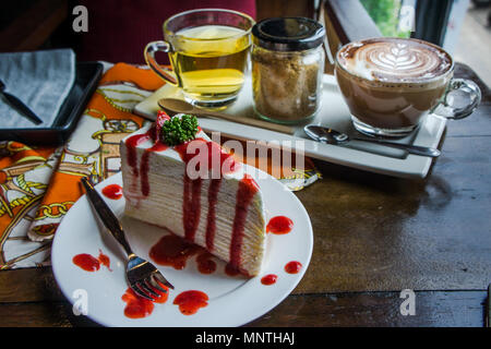 strawberry crape cake on wood table in coffee shop , dessert tasy cake Stock Photo