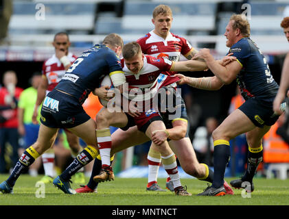 Wigan Warriors' Tom Davies tries to break free of the Warrington line during the Betfred Super League, Magic Weekend match at St James' Park, Newcastle. Stock Photo