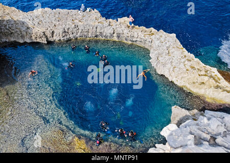 scuba divers and swimmers at Blue Hole, Gozo, Malta, Mediterranean Sea, Atlantic Ocean Stock Photo