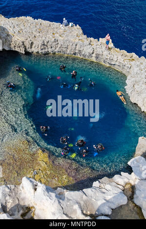 scuba divers and swimmers at Blue Hole, Gozo, Malta, Mediterranean Sea, Atlantic Ocean Stock Photo