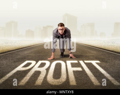 Young determined businessman kneeling before profit sign Stock Photo
