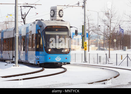 Solna, Sweden - February 27, 2018: Stockholm transport suburban rapid transit tramway with a blue tram class A32 on the Tvarbanan system in service fo Stock Photo