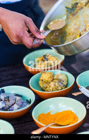 Chef making traditional Sri Lankan chicken curry dish at cooking class Stock Photo