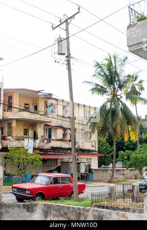 colourful red car parked on street against houses Stock Photo - Alamy