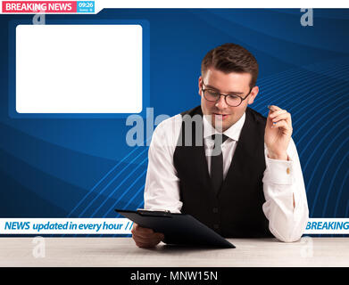 Television reporter telling breaking news at his studio desk with copy space concept Stock Photo