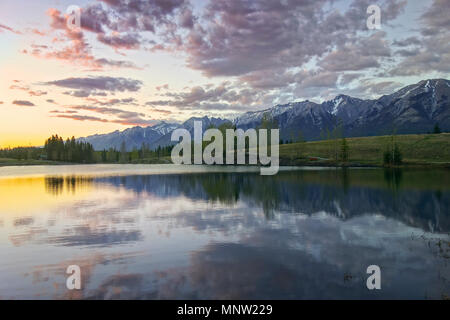 Dramatic Sunset Sky and Scenic Springtime Landscape at Quarry Lake above City of Canmore near Banff National Park, Canadian Rocky Mountains Stock Photo