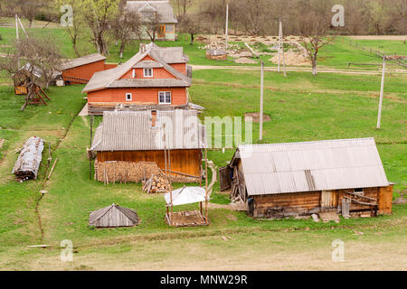 Old-fashioned wooden houses on the outskirts of the forest. Among the Carpathian mountains in Ukraine. Selective focus. Outdoors. Close-up. Stock Photo