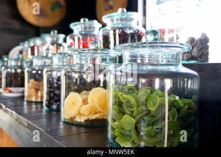 candied, fruit dried in jar sale on the market, kiwi, pineapple, plum, peach Stock Photo