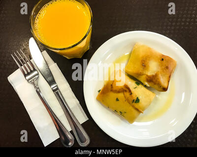 Stuffed pancakes and orange juice for breakfast. Studio Photo Stock Photo