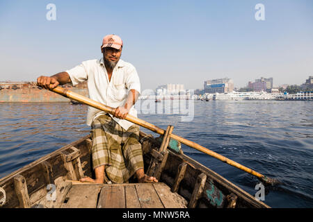 Dhaka, Bangladesh, February 24 2017: Close-up view of a rower in a taxi boat from the perspective of the passenger on the Buriganga River in Dhaka Ban Stock Photo