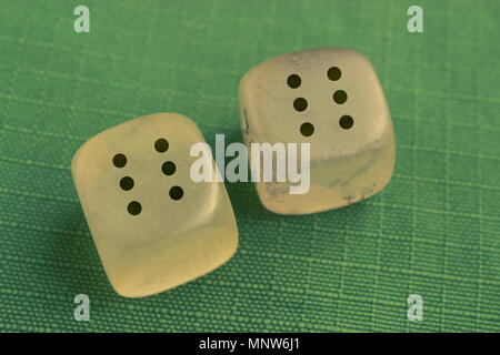 two dice with number six on each on green background Stock Photo