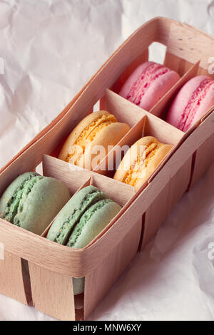 Multicolored macaroon in a box with three compartments Stock Photo