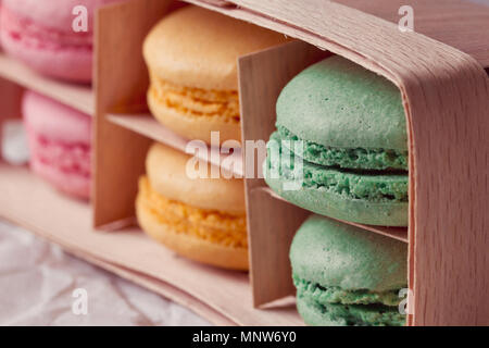 Multicolored macaroon in a box with three compartments Stock Photo